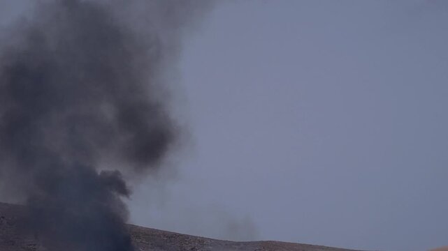 Dense plume of smoke emerges from a fire in the in a recycling plant. Toxicity generated in any one corner of the planet reaches the rest due to air and water currents. Globalisation of toxicity.