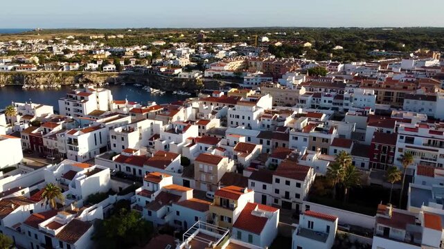 Aerial view of traditional town of Es Castell in the city of Mahon in the balearic island of Menorca at sunset. Spectacular aerial landscape of Menorca with drone