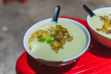 Bowl of tofu soup and coconut milk with ginger sweet syrup