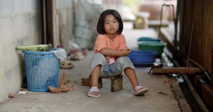 A 5 year old girl in Thailand, Southeast Asia which lives with her single mother, a poor farm worker, in the employer's worker housing in a rural area.	