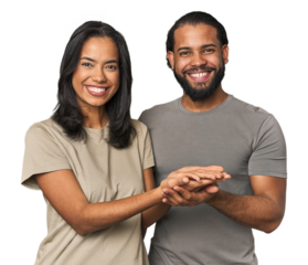 Young Latino couple in studio holding a copy space on a palm.