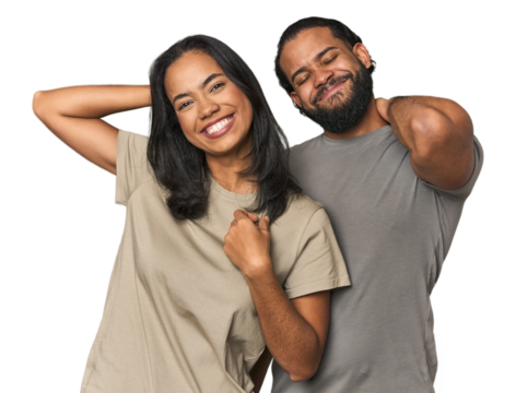 Young Latino couple in studio stretching arms, relaxed position.