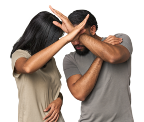Young Latino couple in studio keeping two arms crossed, denial concept.