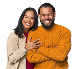 Young Latino couple in studio laughing and having fun.