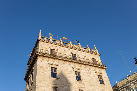 Valencia City, Spain. View of the Palau de la Generalitat Valenciana in the Ciutat Vella district. Flags at the Generalidad palace in Valencia