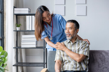 Obraz premium Young female nurse comforting elderly male patient at home