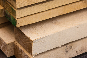 Stacked rough boards closeup photo with selective focus