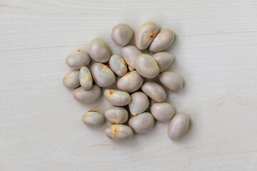 Dried jackfruit seeds on wooden background. Top view.