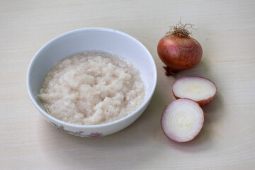 Onion paste (peyaj bata) in a white bowl. It is a common ingredient in Bangladeshi cuisine.