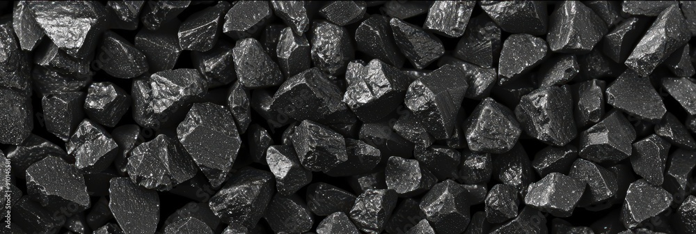 Poster dark coal pieces of various sizes and textures are densely packed together, showcasing their unique 