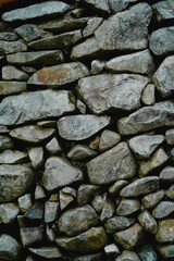 Fototapeta premium Many different size of grey stone wall for abstract background and texture for interior or exterior design. Beautiful patterns, space for work, banner, wallpaper close up. Vertical.