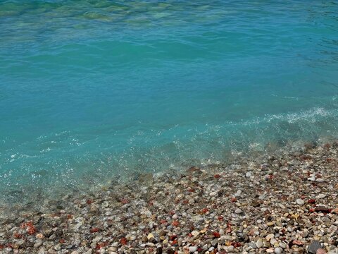 Blue sea waves on pebble beach
