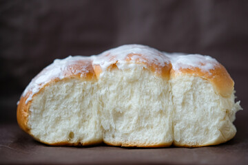 Soft bread buns topped with a sticky glaze. Iced Finger Buns. Small buns with sugar glaze covering.