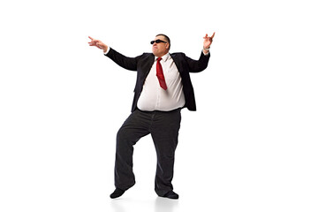 Confident man, businessman in formal wear, black suit and sunglasses, dancing isolated on white background. Positive attitude at work. Concept of business, leisure, achievement, relaxation