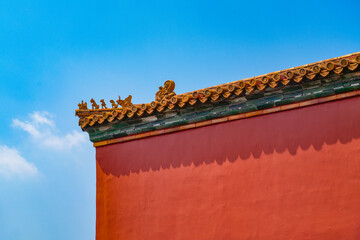 background of red wall and eave of forbidden city and blue sky