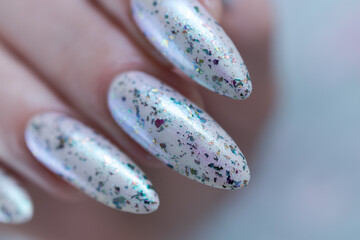 beautiful female hands with long nails light white and green manicure