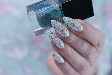 beautiful female hands with long nails light white and green manicure