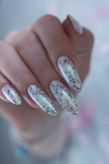 beautiful female hands with long nails light white and green manicure