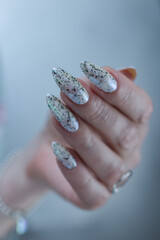 beautiful female hands with long nails light white and green manicure