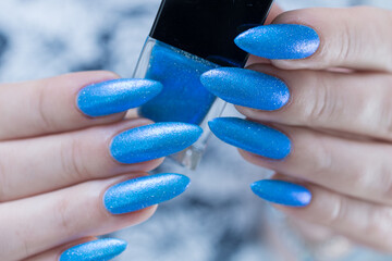 Female hand with long nails and light blue manicure