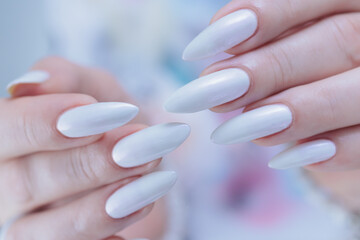 beautiful female hands with long nails light white manicure