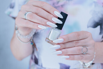 beautiful female hands with long nails light white manicure