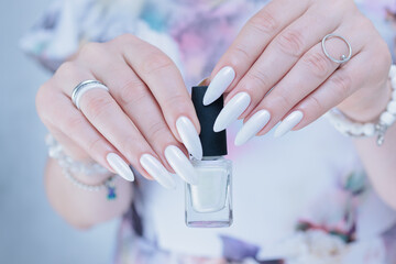beautiful female hands with long nails light white manicure