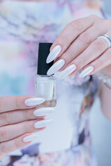 beautiful female hands with long nails light white manicure