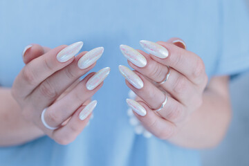 beautiful female hands with long nails light white manicure