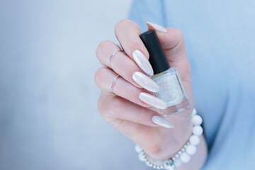 beautiful female hands with long nails light white manicure