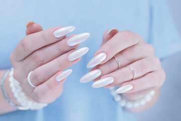 beautiful female hands with long nails light white manicure