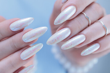 beautiful female hands with long nails light white manicure