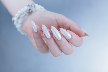 beautiful female hands with long nails light white manicure