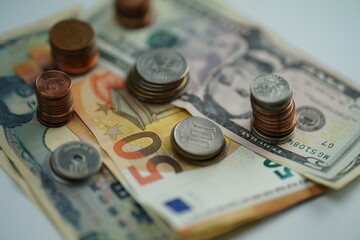 Horizontal photo of various dollar, euro and yen bills and coins of different currencies as a concept of saving and buying foreign currency