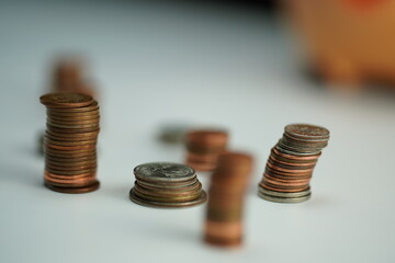 several piles of coins of different currencies as a savings concept