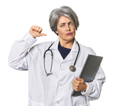 Caucasian mid-age doctor holding laptop feels proud and self confident, example to follow.
