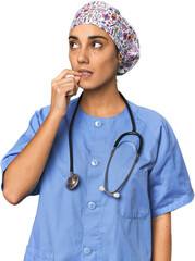 Hispanic nurse in uniform with stethoscope relaxed thinking about something looking at a copy space.