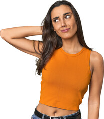 Fototapeta premium Hispanic young woman touching back of head, thinking and making a choice.
