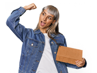 Young caucasian woman presenting a product raising fist after a victory, winner concept.