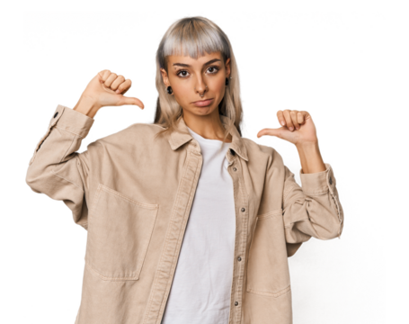 Young caucasian young woman in studio feels proud and self confident, example to follow.
