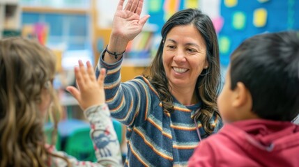 Obraz premium Happy teacher and schoolgirl giving high five during class at school.