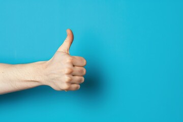 Thumbs up gesture with motivational quote, positive energy