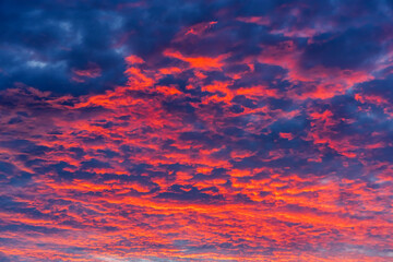 Beautiful view of sunset sky after sun has gone below the horizon. Only the sky above the horizon. Cirrus low clouds. Dramatic sunset. Fantastic dark blue thunderclouds at sunset, Natural composition.