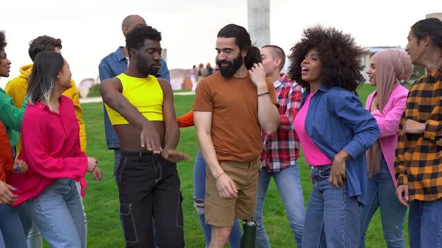 Group of multiracial friends having fun dancing at city park - Diverse young people and friendship concept 