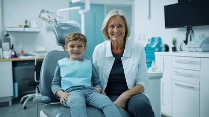 Naklejka premium A happy young boy with brown hair smiles beside a cheerful older woman in a dental office, creating a warm and friendly atmosphere.