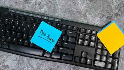 Concept of Pro Bono write on sticky notes isolated on Wooden Table.