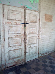 Old wooden entrance door of an old abandoned wooden building