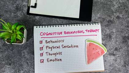 Concept of Cognitive Behavioral Therapy write on book with keyword isolated on Wooden Table.