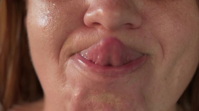 Man touches tip of nose with tongue close-up. Unique human ability.