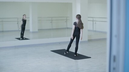Young ballet girl at studio lesson. Training performance. Stretching exercise pose. Ballerina practice balance technique. Classical elegance fitness.